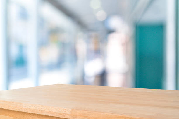 istock Empty wooden table with abstract blurred and illuminated office, lobby or home interior background 1757826523