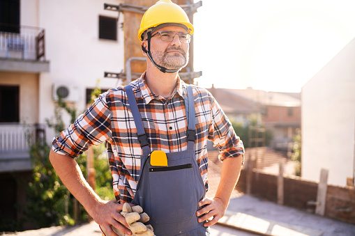 Portrait of an mid-adult Caucasian construction worker, on a construction site