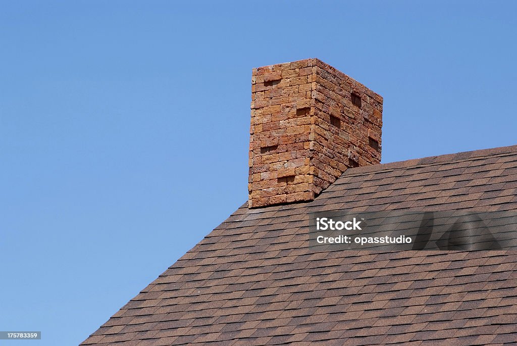 Close up brick chimney on the roof Close up brick chimney on the roof and blue skyClose up brick chimney on the roof and blue sky Air Pollution Stock Photo