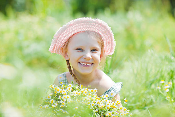 istock girl with camomiles 175784092
