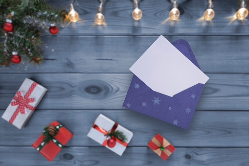 Mockup with horizontal blank sheet of paper. Open holiday envelope with place for text. Flat lay