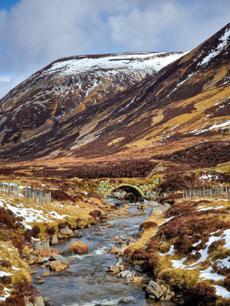 Old stone bridge over river on a cold Autumn day