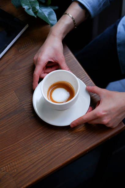 istock woman holding espresso macchiato, ready to drink 1757861270