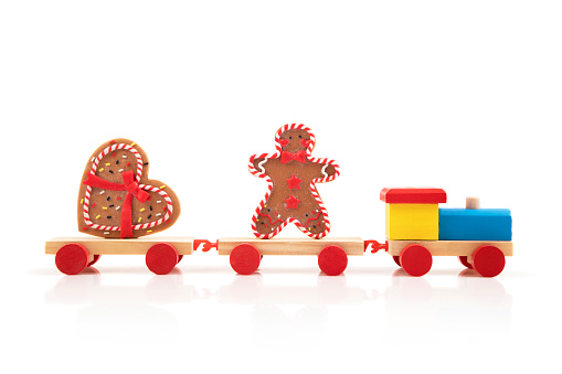 Wooden colorful toy train with gingerbread cookies  isolated on white background