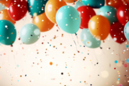 Festive blurred background with balloons and confetti. Copy space.