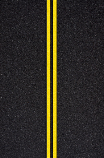 Asphalt road with white and yellow strips