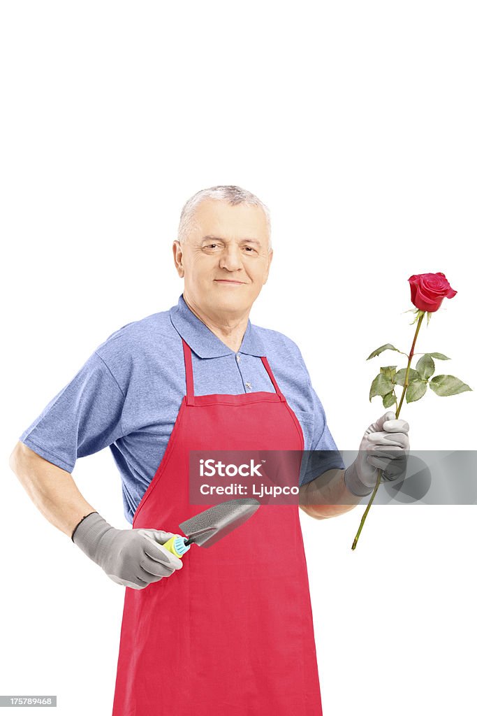 Macho gardener segurando uma flor e Equipamento de Jardinagem - Royalty-free Adulto Foto de stock