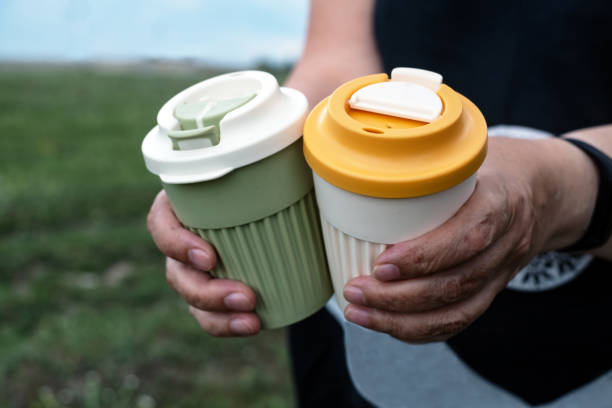 istock Hands hold two stylish reusable glasses with lids. Zero waste concept 1757897207