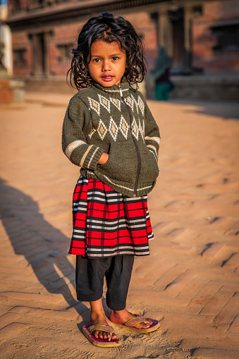Portrait of Nepali little girl, she lives in Bhaktapur. Bhaktapur is an ancient town in the Kathmandu Valley and is listed as a World Heritage Site by UNESCO for its rich culture, temples, and wood, metal and stone artwork.