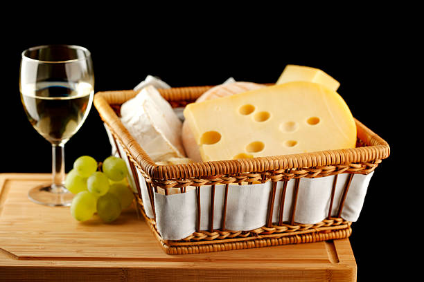 White wine in fine glass with cheese and grape