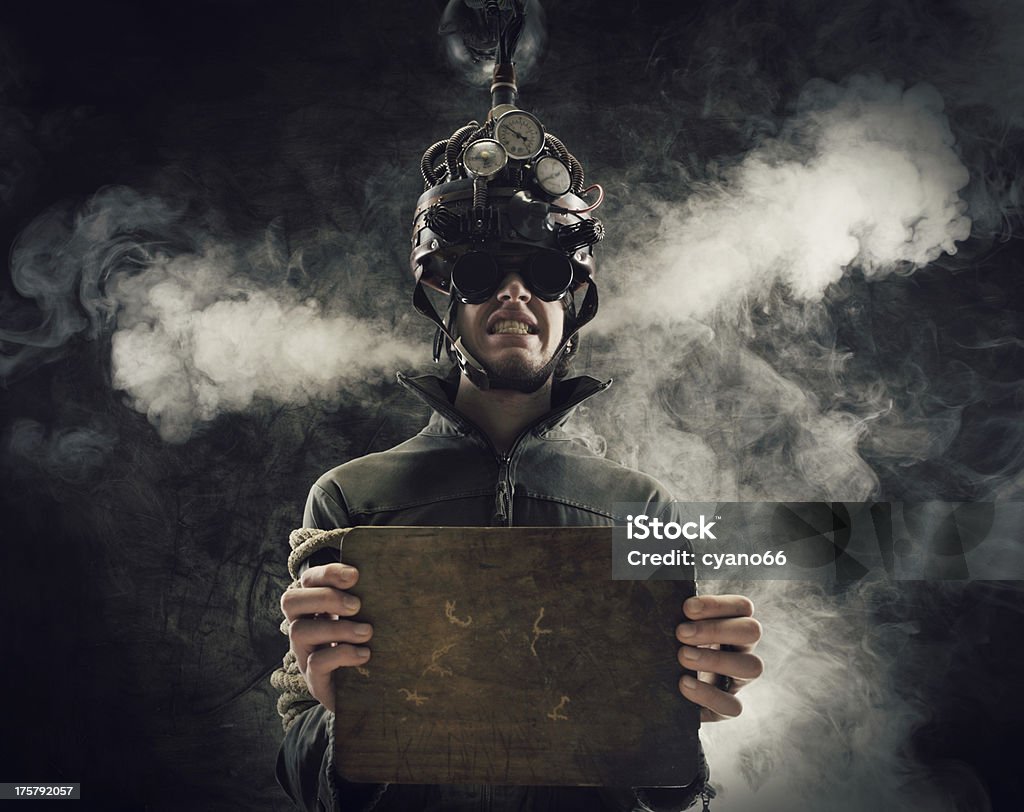 Steaming man with helmet demonstrating mind control concept Man wearing a brain-control helmet, human brain-related experiments Telepathy Stock Photo