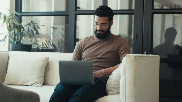 Productive Businessman Working on Laptop in Modern Office Space