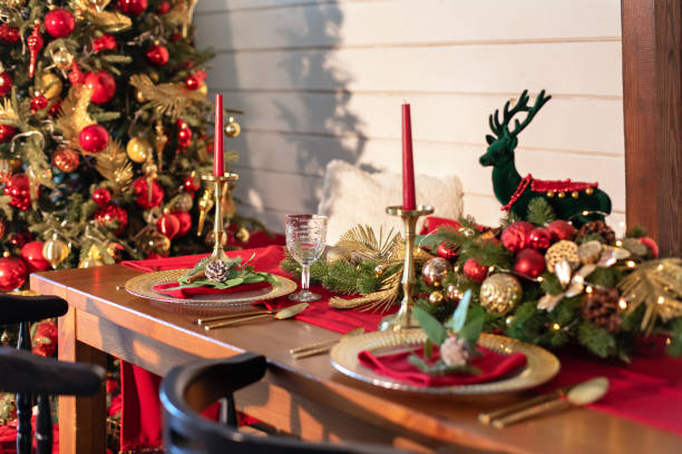 istock Festive table setting for Christmas dinner at home. Holiday Served table with decorations, candles and garland. Beautiful table setting with Christmas decorations and dishware in living room. 1757934566