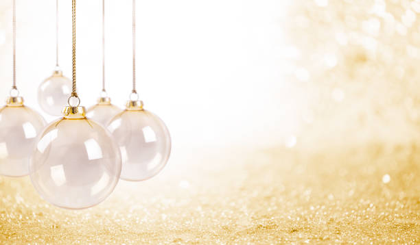 istock Delicate Transparent Glass Baubles on a Golden Glitter Background 1757938892
