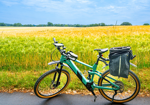 E-Bicycle  in front of the grain field.