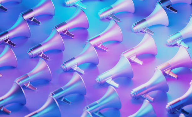 Metallic Megaphones Illuminated By Blue And Pink Lights On Blue And Pink Background