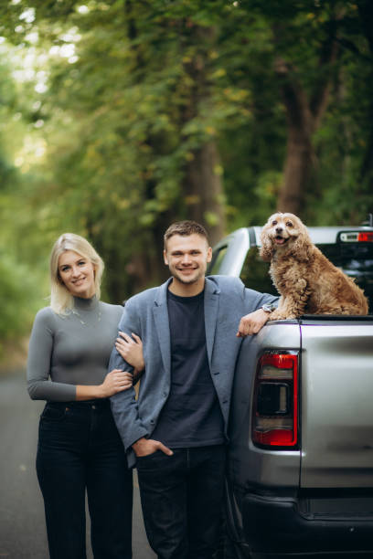 istock a young couple walks with a dog in the forest 1758009117