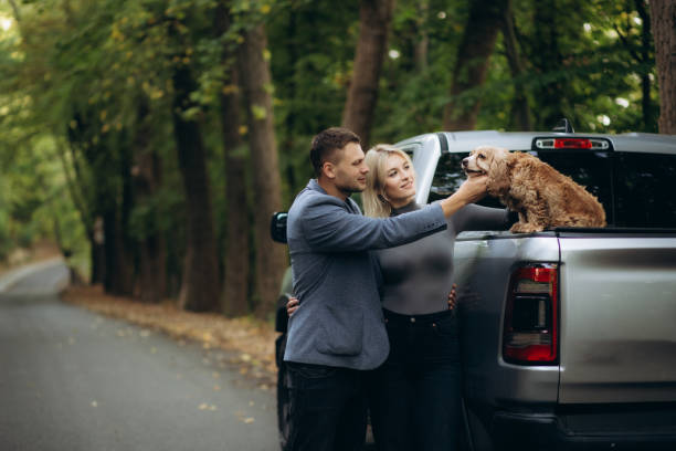 istock a young couple is stroking a dog sitting on a car 1758009124