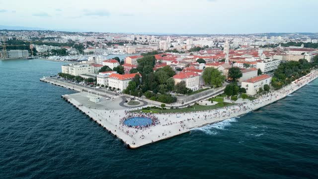 Aerial over the Zadar Sunset Monument Sea Coast, also known as the Monument to the Sun, is a captivating and innovative art installation located in the beautiful Croatian city of Zadar.