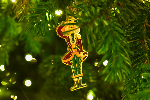 Focus of the Christmas tree Nutcracker ornament. Festival celebration concept.