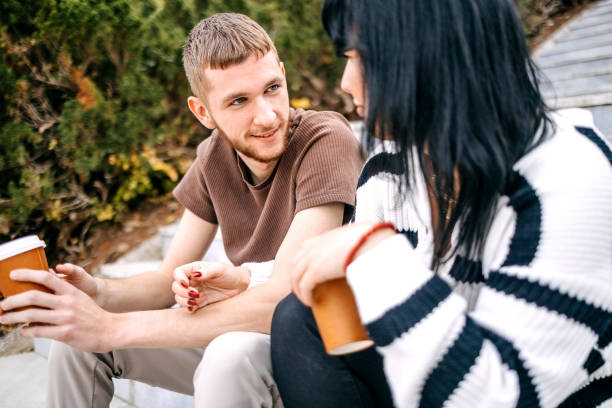 istock Millennial generation couple spending time outside in Autumn drinking coffee 1758032017