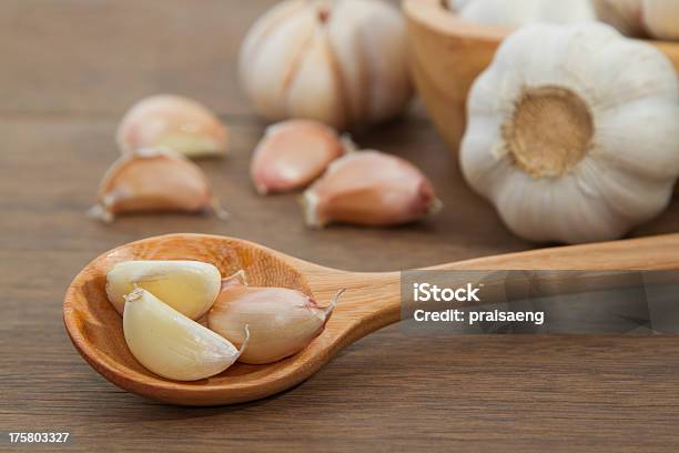 Garlic In Wooden Spoon Stock Photo - Download Image Now - Agriculture, Backgrounds, Cooking