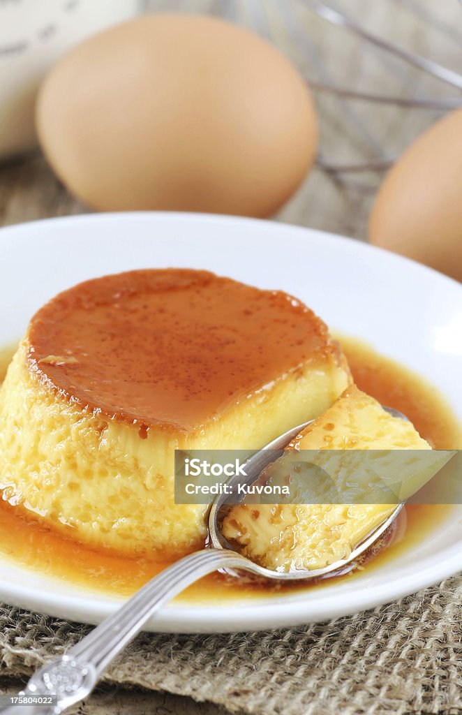 Creme caramel Homemade rustic creme caramel with fresh eggs and a whisk at the background Creme Caramel Stock Photo