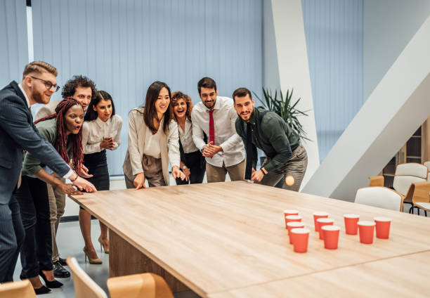istock Young colleagues playing beer pong 1758045424
