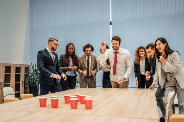 istock Young colleagues playing beer pong 1758052219