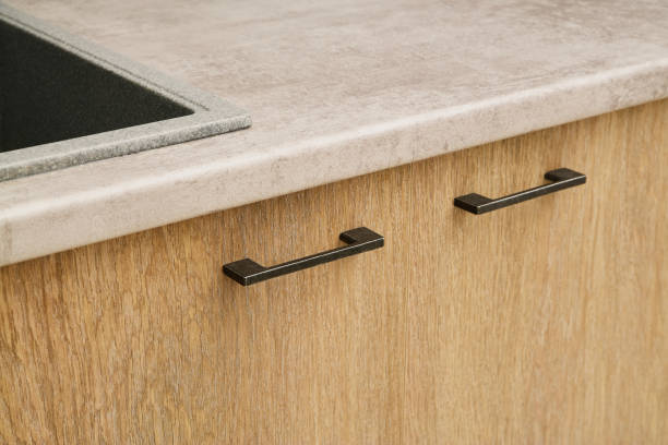 istock wooden kitchen facades close-up. black modern metal handle 1758057075