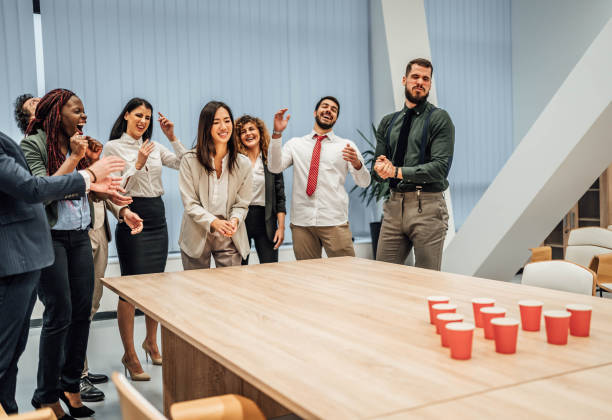 istock Young colleagues playing beer pong 1758058792