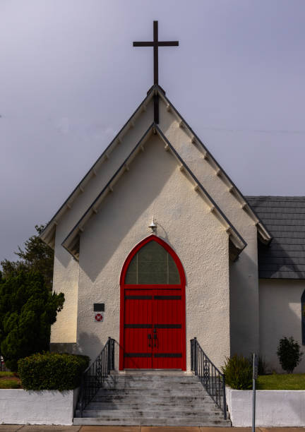 istock Chapel with arched red door and cross 1758059384