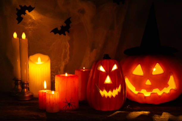 istock Halloween pumpkin lantern with burning candles on a dark textured background with cobwebs and spiders.Halloween pumpkin jack lantern.Holiday concept.Halloween Jack o Lantern Pumpkin with a spooky face 1758064915