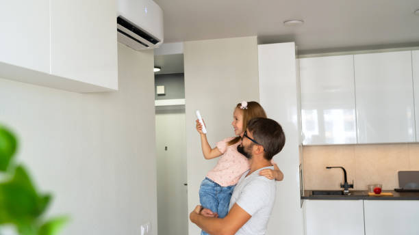 istock Family adjust comfortable temperature of air conditioner using remote control. 1758067658