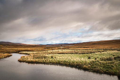 A cloudy autumnal HDR image of Lon Achadh na h-Albhne and surrounding landscape at Inchkinloch in Sutherland, Scotland