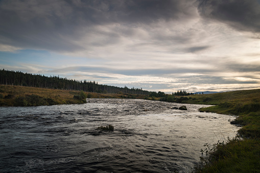 An autumnal dusk HDR image of the River Naver, known as a salmon river, and the Naver Forest in Strathnaver, Sutherland, Scotland