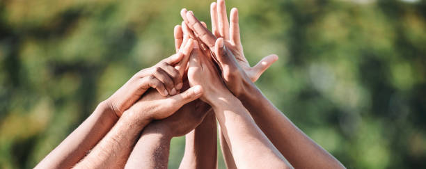 istock People, teamwork and high five in nature, support or collaboration for motivation or outdoor goals. Closeup of group hands together in team building, solidarity or trust in unity or community outside 1758084837