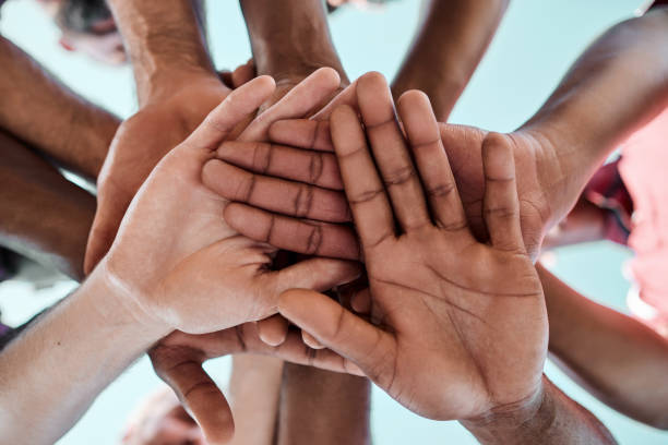 istock People, teamwork and hands together in motivation, collaboration or community for goals below. Closeup of group piling in team building, solidarity or trust in support for sports, rugby or match 1758084852