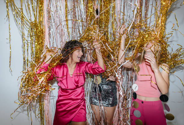 Photo of a group of female friends celebrating together the coming of a New Year's together on a house party