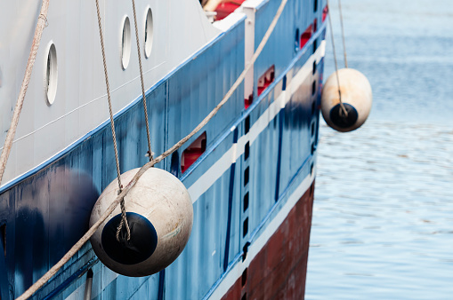 Fenders on the side of a fishing trawler.