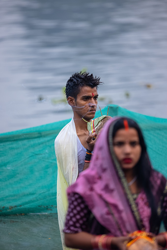 Ghaziabad, Uttar Pradesh, India - October 2022: Chhath Puja, Indian hindu male devotee performing the rituals and festival of chhath.