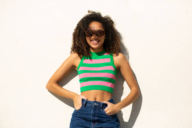 istock happy young woman by white wall 1758100420
