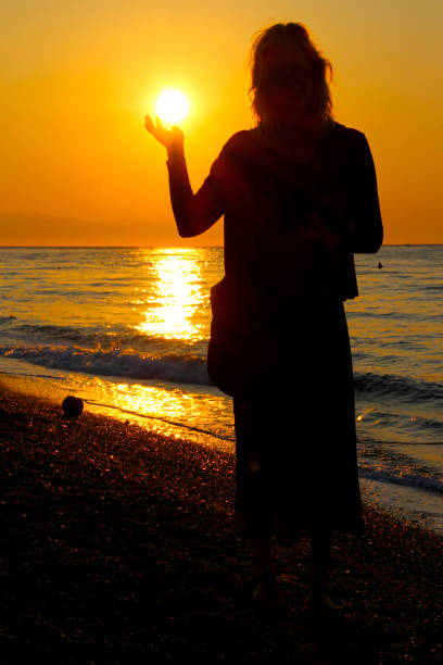 istock Woman in silhouette catch the sun 1758103215