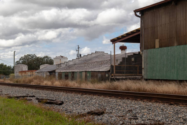 istock Abandoned warehouse and industrial yard by railroad tracks 1758115800