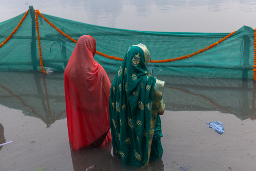 Ghaziabad, Uttar Pradesh, India - October 2022: Chhath Puja, Indian hindu female devotee enjoying the rituals and festival of chhath.