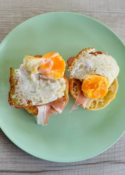 istock Sunny side up view of  toasted muffins with fried eggs and prosciutto 1758127717