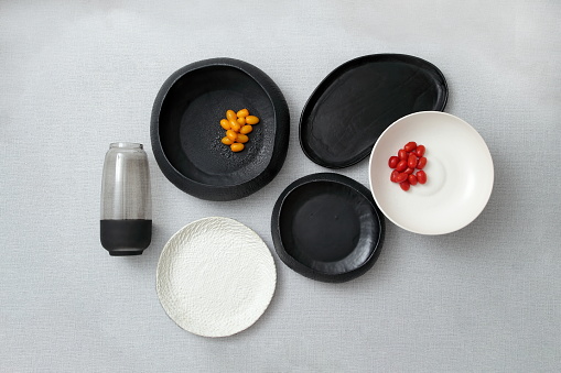 decorative assemblies seen from above with plates, bowls and objects with fruits and vegetables