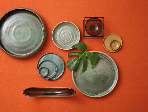 decorative assemblies seen from above with plates, bowls and objects with fruits and vegetables