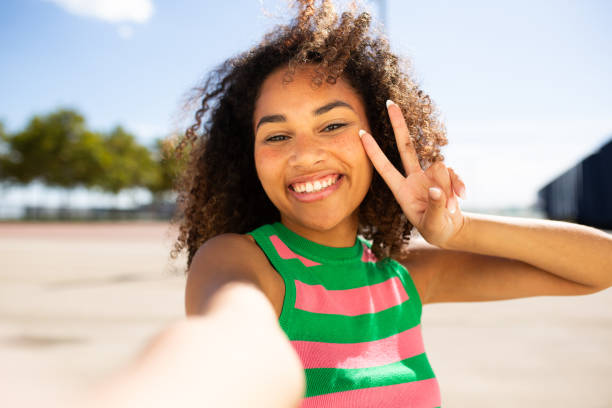 istock happy young woman taking selfie 1758135385