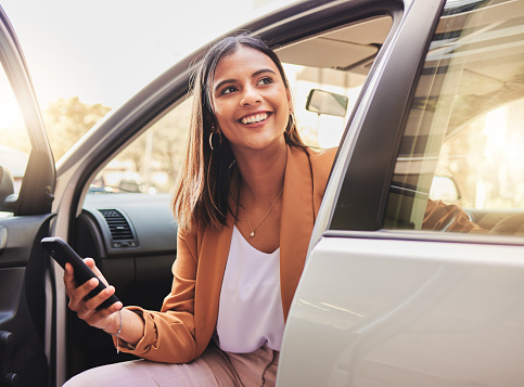 Thinking, smile and a woman in a car with a phone for communication, social media or the internet. Happy, idea and a young girl in transport or a taxi with a mobile for travel information or update